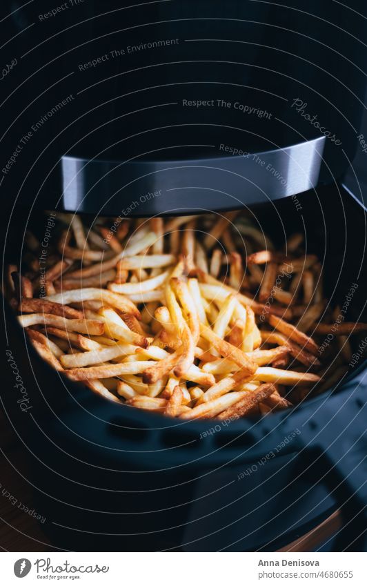 Air fryer with french fries on the worktop air fryer deep-fried French fries chips finger chips French-fried potatoes airfryer no oil comforting food
