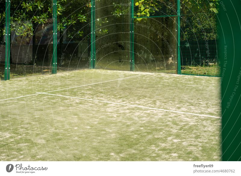 Empty paddle tennis court with sand empty nobody background sports outside nature play net energy life sunset happy light spain grass green concrete outdoors