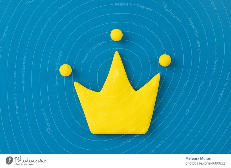 Simple 3d yellow crown symbol on blue background. Concept of win and success, top rank quality status. abstract aristocracy authority award best business