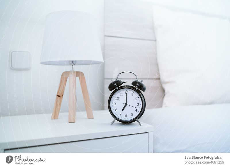 alarm clock at 7 am on bedroom during morning, wake up concept home house white alert bell insomnia work hotel clock dial relaxation hours arousing analog