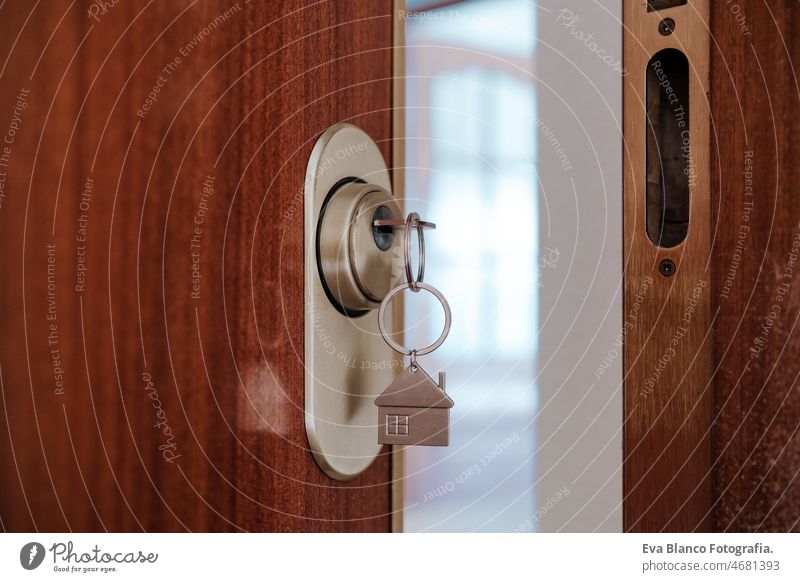 door home with keys and keyring with house shape.Home and lifestyle. Real state concept nobody real state open entrance indoors door handle keyhole hardware
