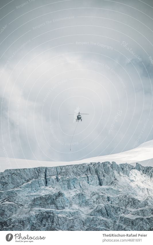 Helicopter flies over glacier Glacier Sky Flying transport Ice Snow Frozen Switzerland Alps
