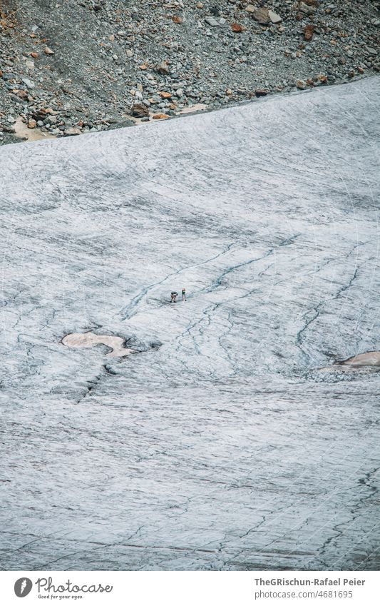 People walk across the glacier Glacier Gravel cracks Cervasse Scree stone Snow Ice Walking peril Melt