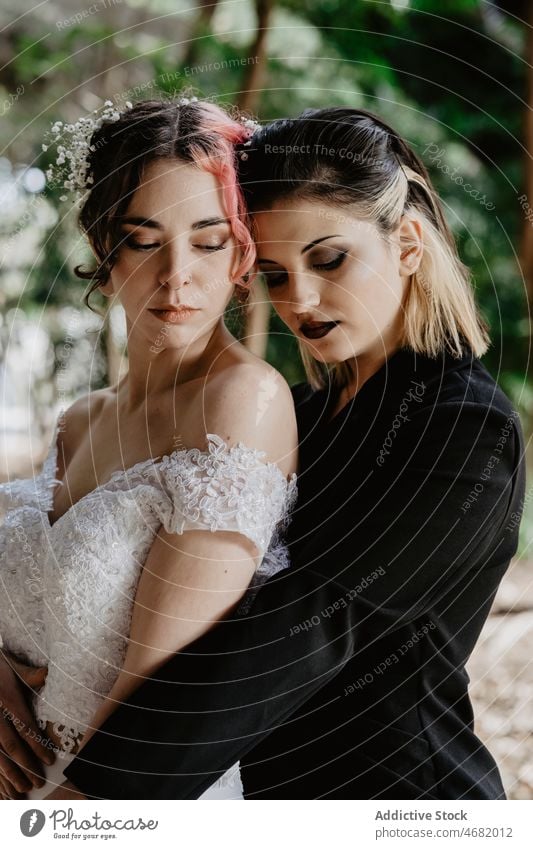 Newlywed couple of homosexual women in summer garden newlywed lesbian lgbt wedding eyes closed hug love fancy park embrace together female relationship equal