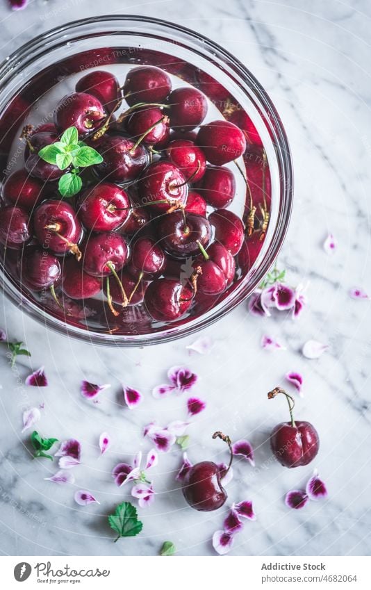 Glass bowl of red cherries cherry vitamin natural organic kitchen nutrition healthy food flavor tasty delicious marble delectable product vivid light bright