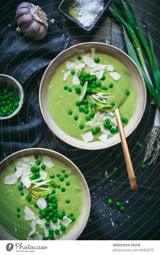 Peas cream on dark table pea soup culinary gastronomy kitchen puree meal healthy food green onion spoon napkin serve nutrition dish fresh ingredient organic