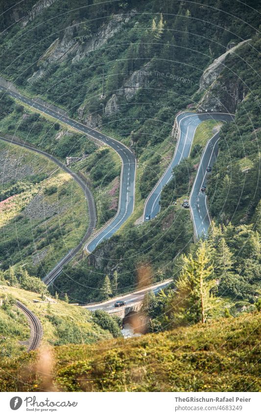 Alpine road with hairpin bends alpine pass Vantage point Street Manmade structures Steep Forest mountain Furka Pass