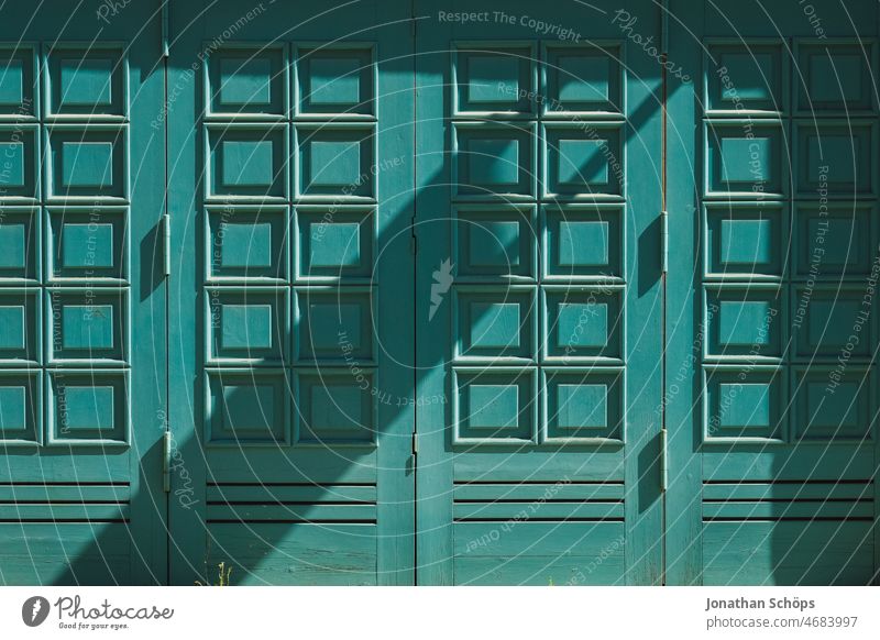 turquoise doors with shadow Goal gate Garage door Entrance Way out Wall (building) Architecture Turquoise Shadow Sun Town urban Wooden gate Wooden door