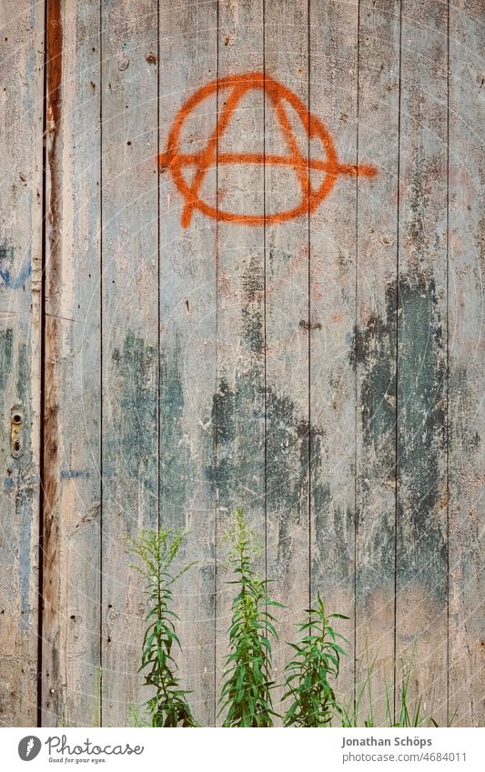 Anarchy symbol on wooden wall Anti-fascism Politics and state Left Chaos Graffiti Daub Political movements Punk Protest Resist Multicoloured Exterior shot
