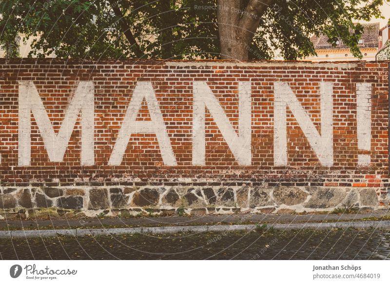 Man. Writing on wall masculinity Exclamation invitation Wall (barrier) writing Letters (alphabet) Characters Wall (building) Word Typography Text Communication