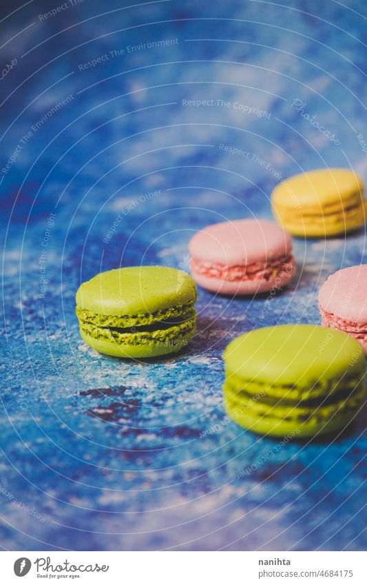 Variety of colorful macarons over a blue background macaroons gourmet food delicious sweet tasty delicatessen dessert cake bake bakery modern stylish food yelow