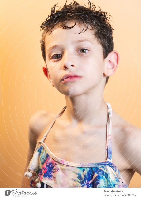 Portrait of a 6 year old boy wearing a bikini top, isolated on a light background Bikini Top Portrait photograph male cute fashion bisexual Summer Beautiful