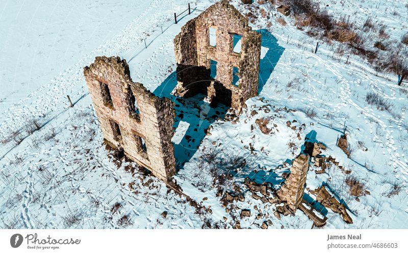 Old farm house ruins in winter ancient rock decay frost land hill snow trees photography temperature outdoors ice stone mold building season falling apart rural