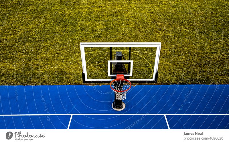 Blue Basketball court with clear hoop and grassy background autumn sunny color no people nature land summer drone net outside basket scenic arena outdoors day