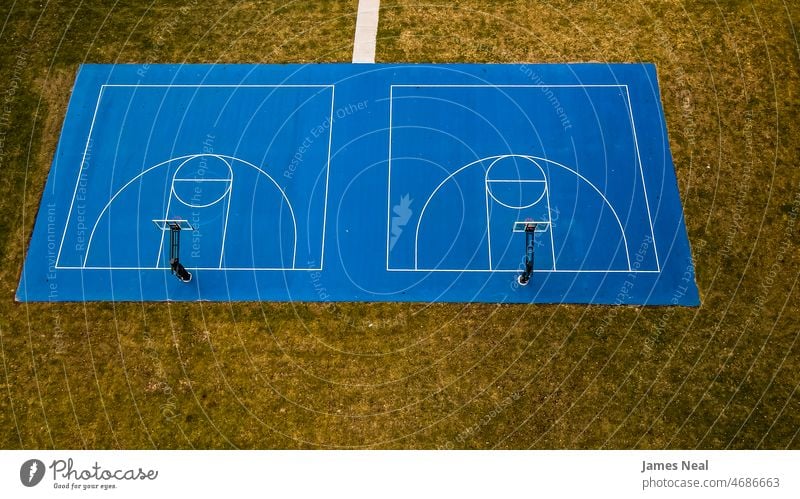 Blue basketball court with basketball hoop and grassy background Grass Autumn sunny Colour no people Nature Ball country Summer Drone Net outside Basket