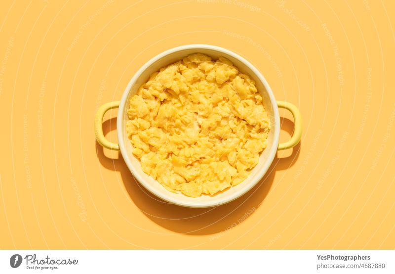Scrambled eggs above view minimalist on an orange background american breakfast bright brunch close-up color copy space creamy cuisine delicious diet dish