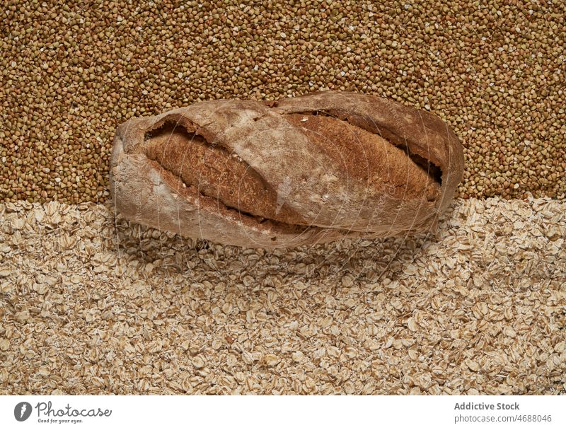 Baked bread on raw grains buckwheat oat bakery baked cereal organic loaf background food natural whole nutrition fresh tasty yummy appetizing wholegrain healthy