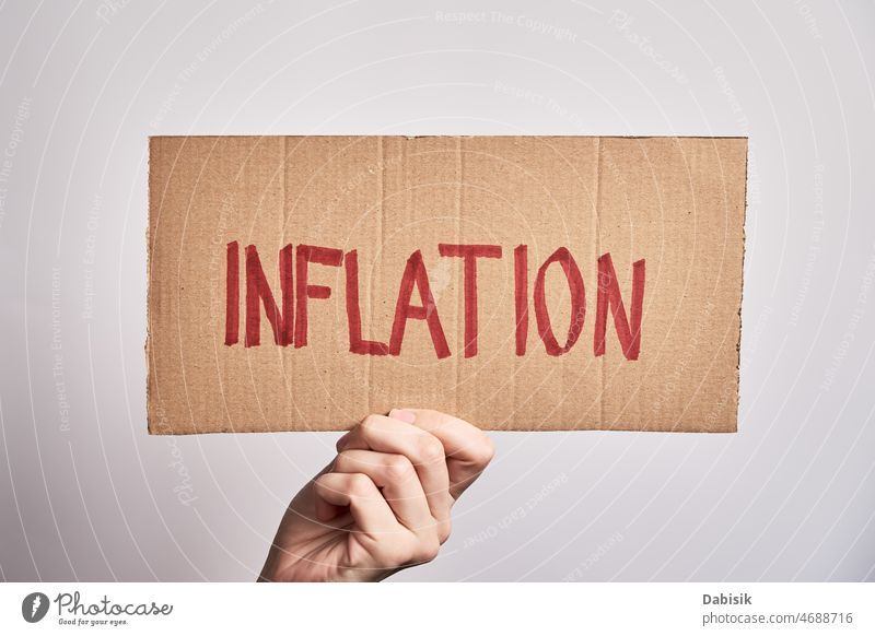 World inflation concept. Woman hold sheet with word inflation crisis finance economic risk consumer high currency us europe business dollar money wealth growth