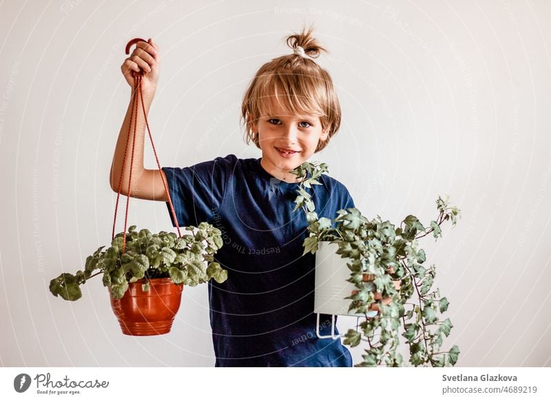 Cute blonde boy plant lover hand hold flower pot child kid gardening green happy nature holding lifestyle care little young person spring summer growth leaf