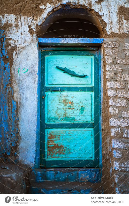 Colorful door of old building house destruct street shabby weathered entrance desolate wall porch egypt local style property worn out district residential
