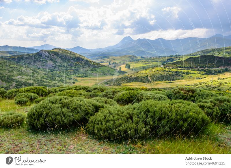 Mountainous valley with small village and green fields mountain landscape nature settlement slope range highland scenery countryside picturesque grassy hill