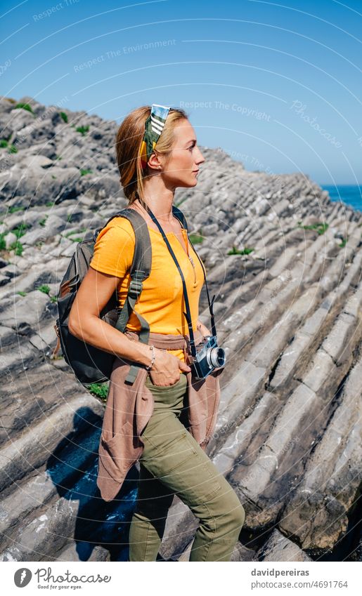 Hiking woman watching flysch rocks landscape young hiking backpack excursion trekking portrait one person exercising trip explore weekend discovery inspiration