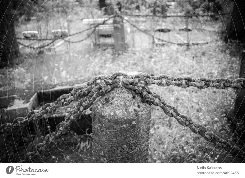 chain fence with granite columns in old Latvia cemetery beauty black chains city countryside day forest forever grass grave grave fence green iron metal