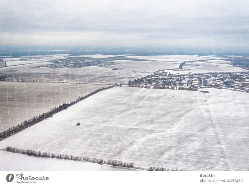 Ukraine winter landscape view from the plane February above aerial background city clouds cold dramatic empty environment europe farm field flight fly fly away