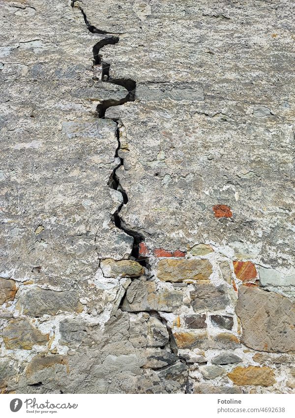 A thick crack runs through the masonry of an old building. Crack & Rip & Tear Wall (building) Wall (barrier) Old Broken Decline Colour photo Transience Facade