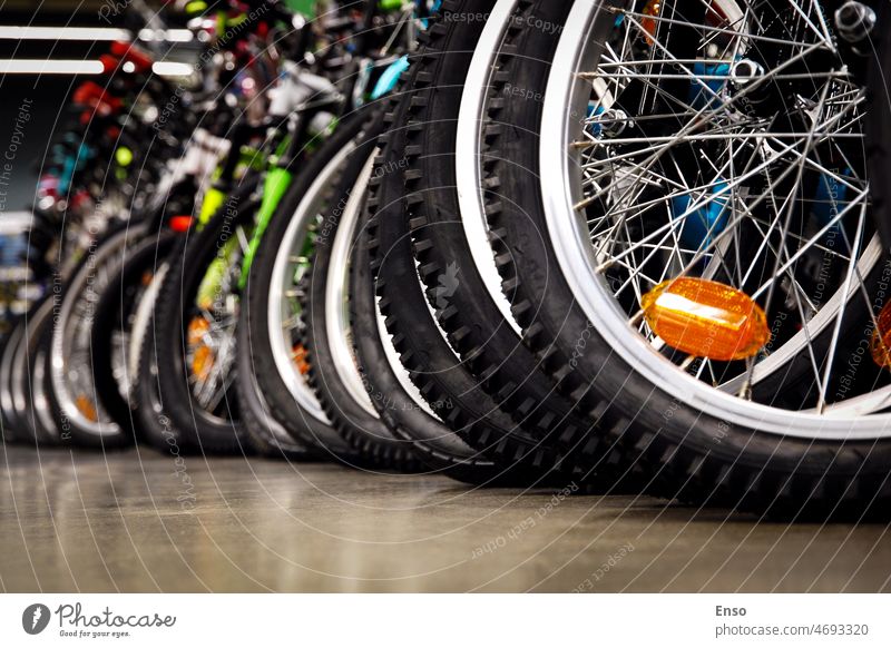 Bikes in a sports store, tires closeup, bicycle wheels in a row in bikes store shop sale cycling summer mountain bike lifestyle transport ecological fitness