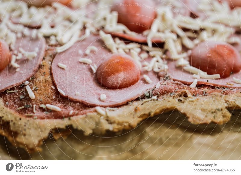 frozen low carb pizza with toppings and crust - dough made with almond flour Frozen Deep frozen Low Carb Diet Pizza Tomato Cheese herbs Crust Salami