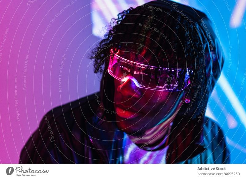 Black man in futuristic glasses cyberpunk future high tech trendy modern wall calm glow male black african american contemporary guy appearance shiny style room