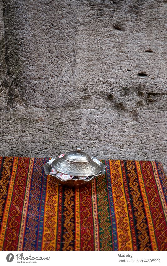 Traditional striped oriental tablecloth on the table of a tea house in the old town of Eminönü in summer in Istanbul on the Bosphorus in Turkey Old Ottoman
