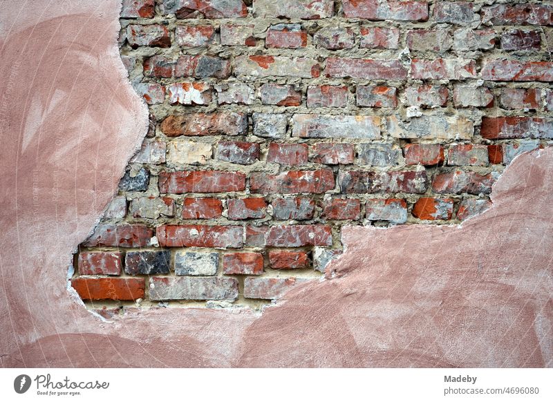 Old brickwork of red brick with crumbling plaster of an old factory in the district of Margaretenhütte in Giessen on the river Lahn in Hesse, Germany
