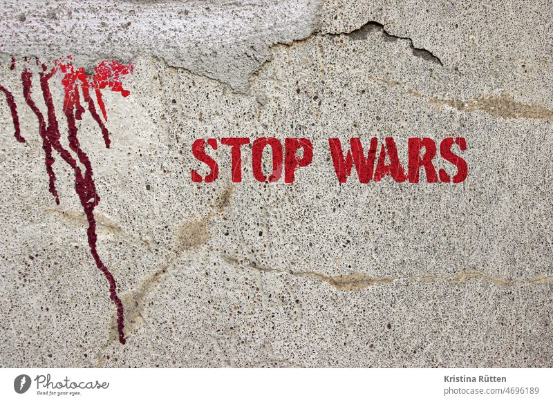 stop wars graffiti on a wall with red paint marks War Stop Quit Peace world peace pacifism Global International utopia non-violence pacifist non-violent demand