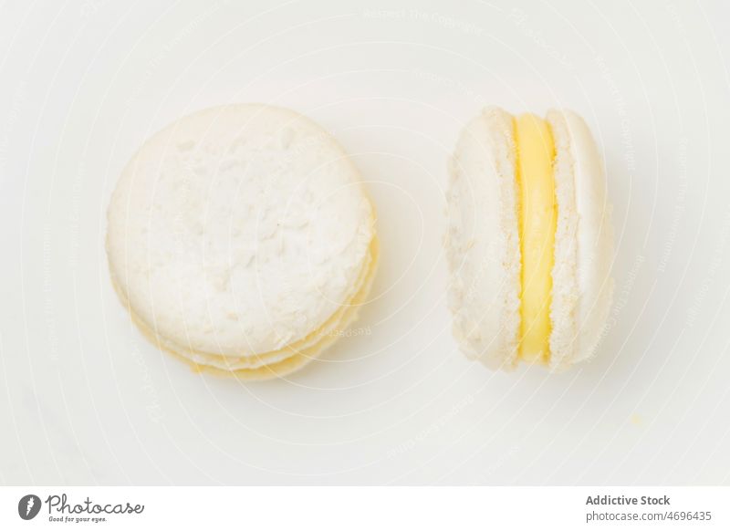 Vanilla macaroons with filling on table macaron vanilla dessert sweet confection confectionery indulge treat food flavor fresh tasty delicious yummy appetizing