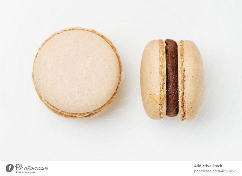 Coffee macaroons served on white background macaron two coffee dessert sweet confection confectionery indulge treat food flavor fresh tasty delicious yummy
