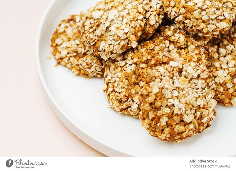 Oatmeal cookies on white plate oatmeal dessert sweet confection confectionery pastry flavor treat calorie food fresh tasty delicious yummy appetizing bright