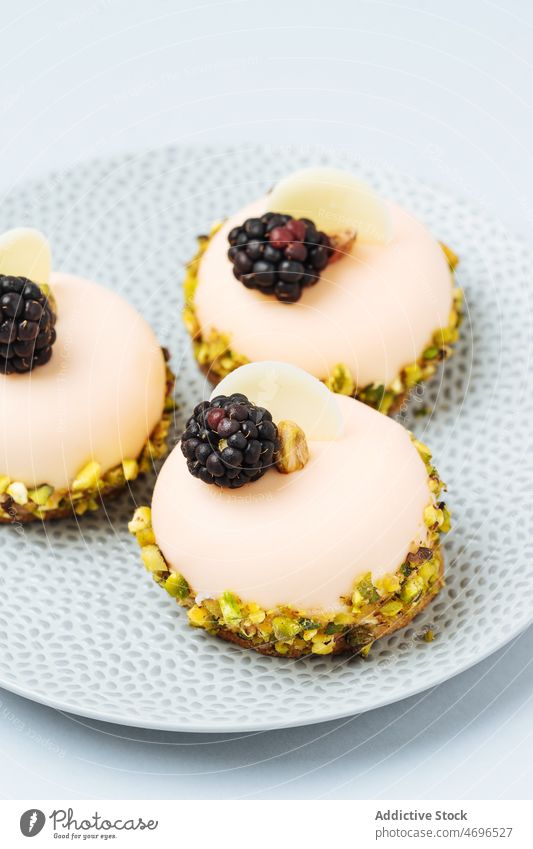 Sweet pastries with cream and blackberries pastry dessert blackberry sweet sophisticated confection decor cuisine confectionery treat food fresh filling tasty