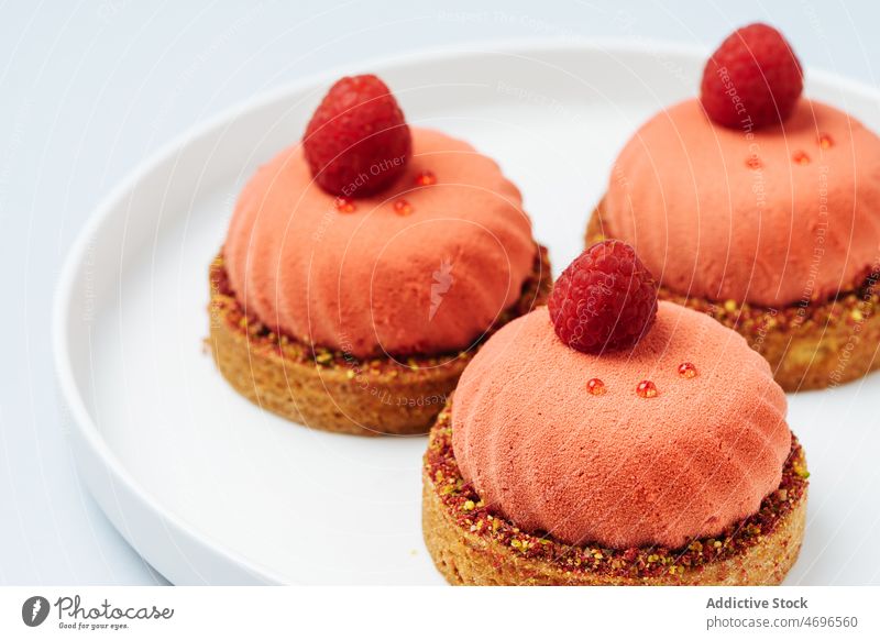 Sweet mousse pastries with raspberries pastry raspberry tartlet dessert sweet sophisticated confection decor confectionery treat food fresh tasty delicious