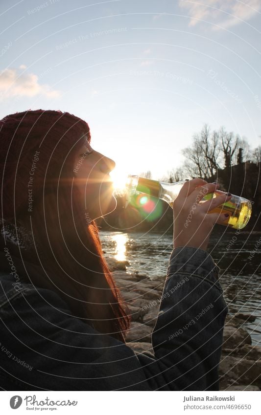 Woman drinking beer by river Beer Alcoholic drinks Bottle Drinking Beverage Glass Day Exterior shot Colour photo Party Feasts & Celebrations Lifestyle