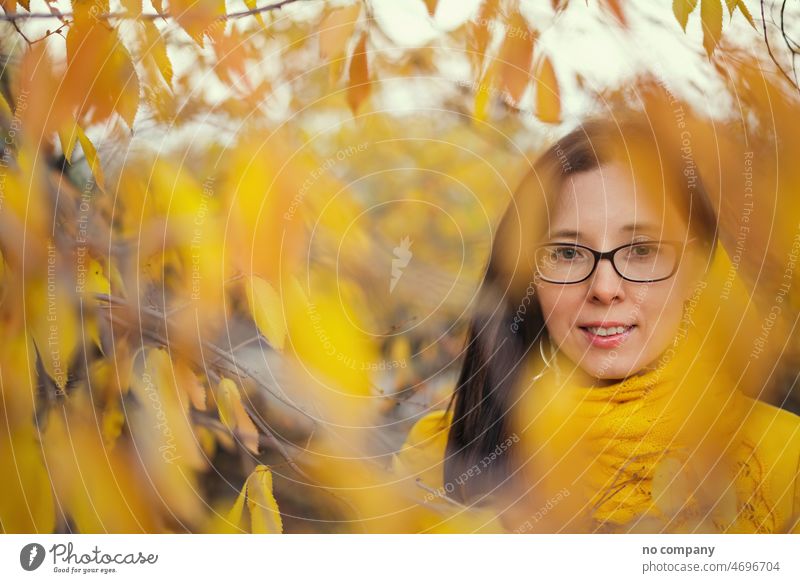 beautiful woman in a yellow jacket and scarf on an autumn forest background fall portrait face pretty cute beauty leaves nature outdoors smiling happy joy