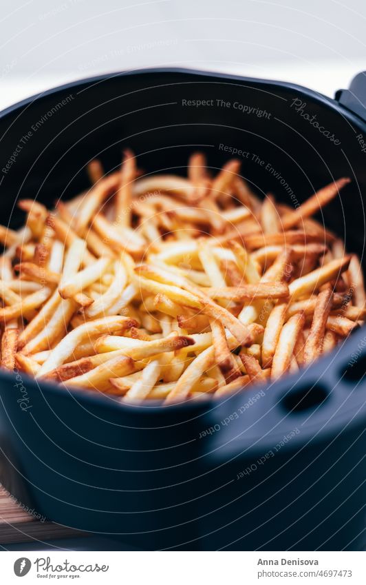 Air fryer with french fries on the worktop air fryer deep-fried French fries chips finger chips French-fried potatoes airfryer no oil comforting food