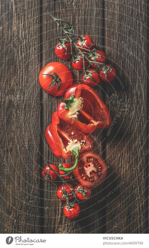 Composition of red vegetables at rustic wooden background composition raw tomatoes bell pepper kitchen cooking preparation delicious healthy organic ingredients