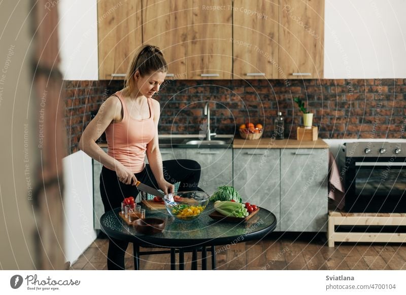Sports woman cooking healthy eat at home salad celery pepper lifestyle kitchen vegan diet vegetables preparation concept beautiful food ingredients happy
