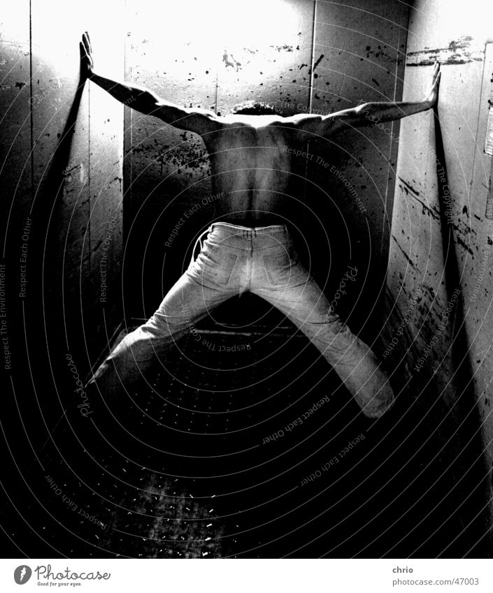 resistance Pants Wall (building) Elevator Scratch mark Gray scale value Dark Barefoot Human being Fight Musculature Metal Black & white photo Contrast Bright