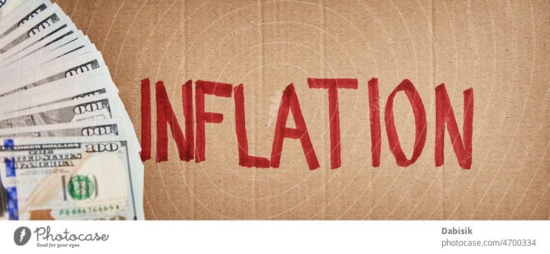 World inflation concept. Cardboard with word inflation and usd banknotes crisis finance economic bill risk consumer high currency business earnings dollar