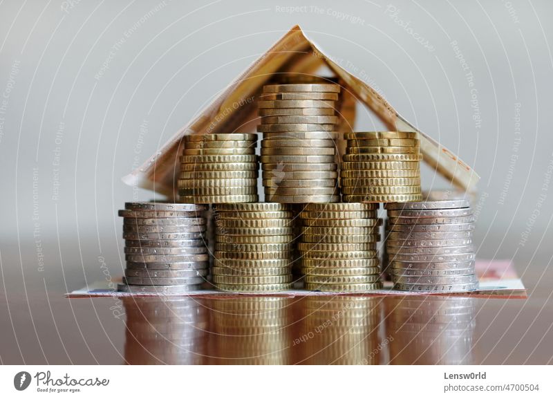 A house made out of Euro coins and bills: Mortgage, rent, investment buy cash concept construction currency economic estate finance fund home housing inflation
