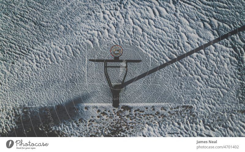 aerial of basketball court in winter matte - image technique snowfall landscape - scenery frost moody multi colored basketball hoop tranquil scene united states