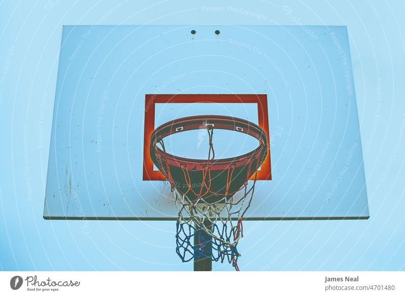 Old school basketball hoop at the park with red white and blue striped net Sports Event basketball - sport tranquility abstract Atmospheric Mood Sports Activity